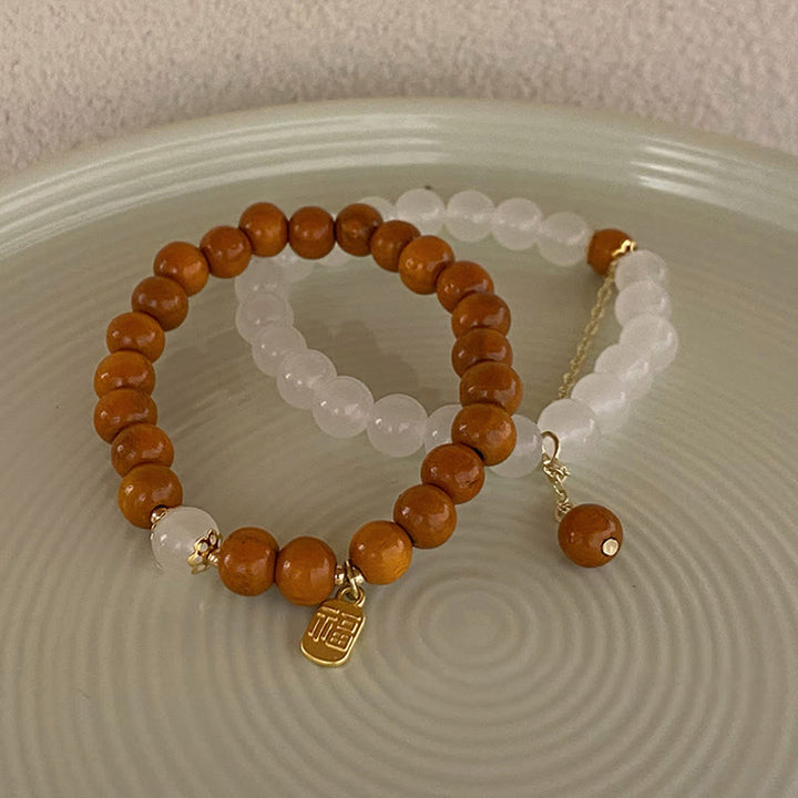 Buddha Stones Armband met bedeltje van sandelhout, kattenoog en Fu-figuur. - image 16