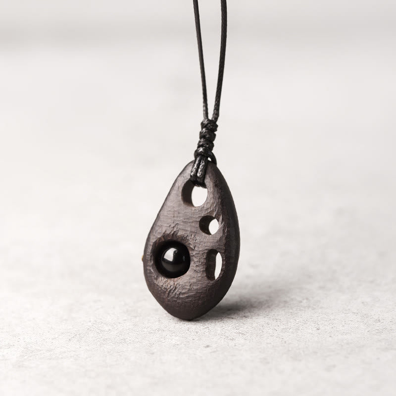 Buddha Stones Ketting van ebbenhout met holle ingelegde obsidiaan, symbool voor vrede en kalmte. - Ebbenhout Obsidiaan - image 0