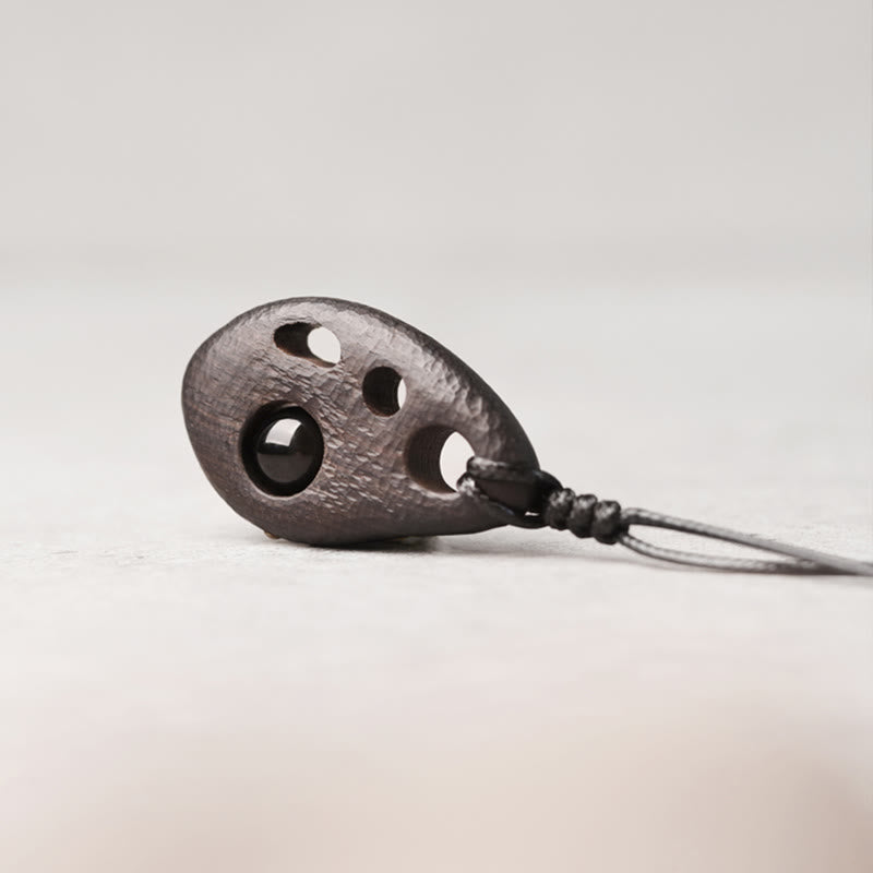 Buddha Stones Ketting van ebbenhout met holle ingelegde obsidiaan, symbool voor vrede en kalmte. - image 1