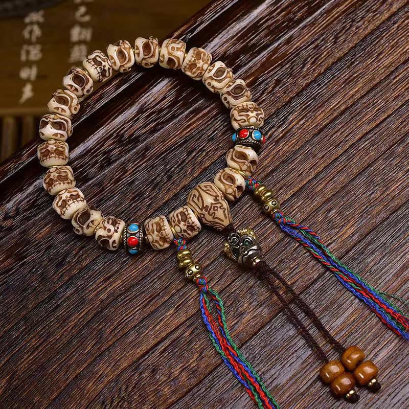 Buddha Stones Tibetaanse armband met Garuda-motief, gesneden uit kameelbot en voorzien van een beschermende kwast . - image 1