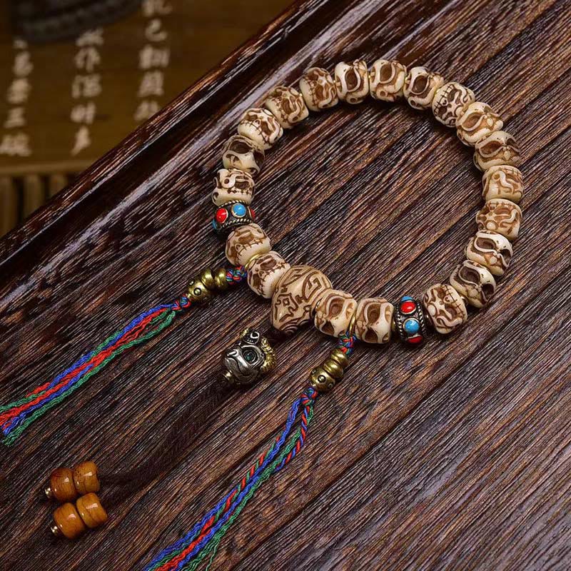 Buddha Stones Tibetaanse armband met Garuda-motief, gesneden uit kameelbot en voorzien van een beschermende kwast . - Kwastje (Polsomtrek: 14-17 cm) - 11 mm - image 0