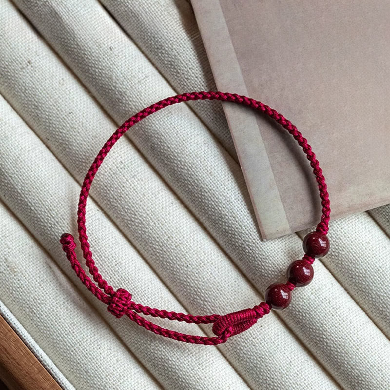 Buddha Stones Handgemaakte Armband van gevlochten touw met cinnaberkralen en een kalmerend effect. - image 1
