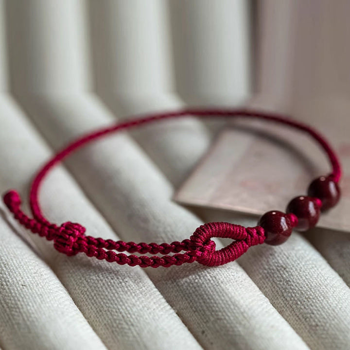 Buddha Stones Handgemaakte Armband van gevlochten touw met cinnaberkralen en een kalmerend effect. - image 3