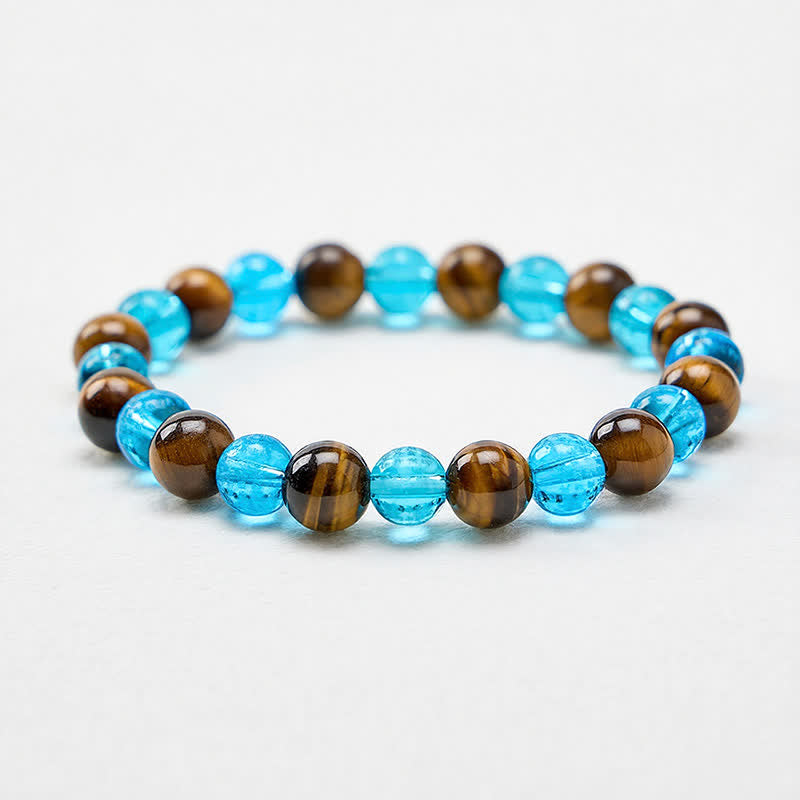 Buddha Stones Ronde Armband met tijgeroogblauwe Liuli-glaskralen en de tekst 'Moed'. - image 1