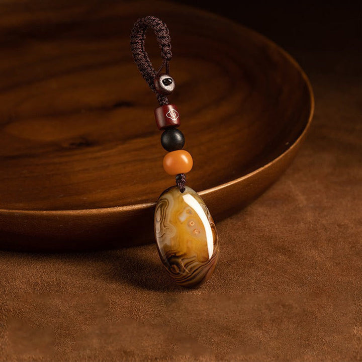 Buddha Stones Willekeurige sardonyxsteen positieve sleutelhanger - image 1