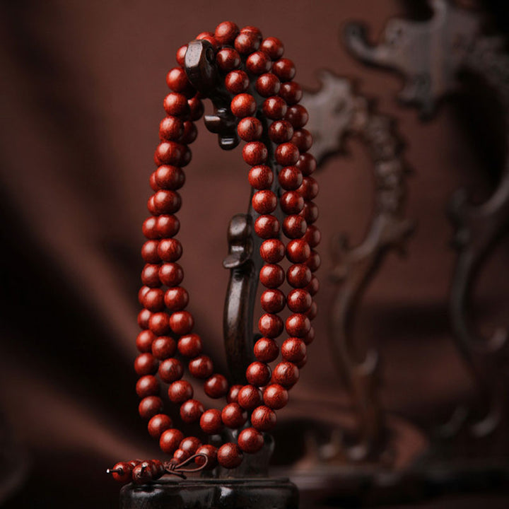 Buddha Stones Tibetaanse Mala - Armband met 108 kralen van rood sandelhout met kleine blaadjes. - image 1