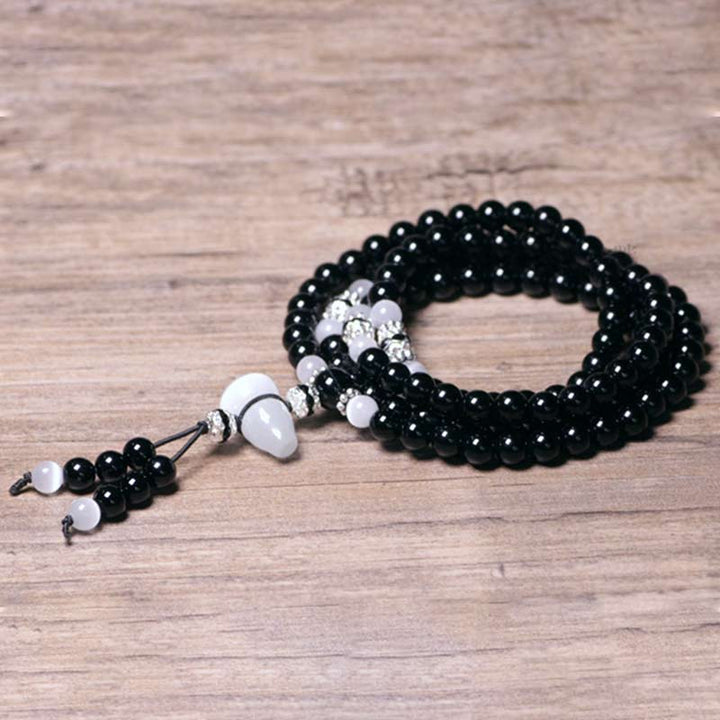 Buddha Stones Armband met kralen van zwarte onyx en witte kristallen - image 5