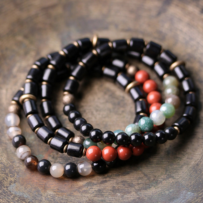 Buddha Stones Armband voor stellen van ebbenhout, rode jaspis, mosagaat, kristal en koper met vredesmotief. - image 1