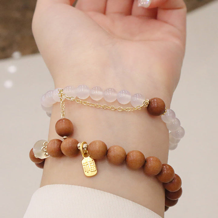 Buddha Stones Armband met bedeltje van sandelhout, kattenoog en Fu-figuur. - image 0