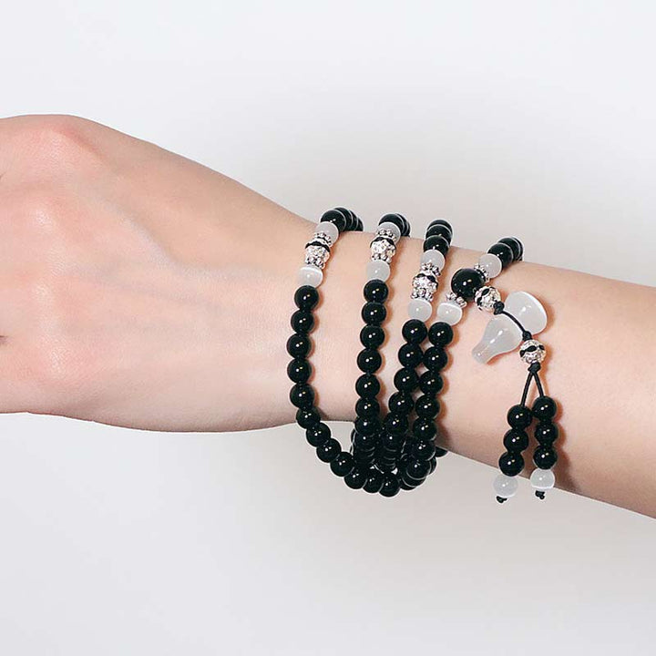 Buddha Stones Armband met kralen van zwarte onyx en witte kristallen - image 6