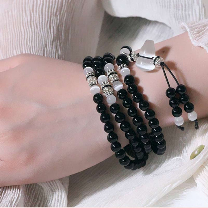 Buddha Stones Armband met kralen van zwarte onyx en witte kristallen - image 4
