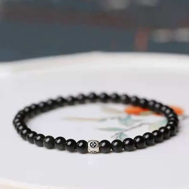 Buddha Stones Armband van natuurlijke zwarte obsidiaan en rookkwarts voor zuivering en versterking. - 6mm - Zwarte obsidiaan - 17-19 cm - image 0