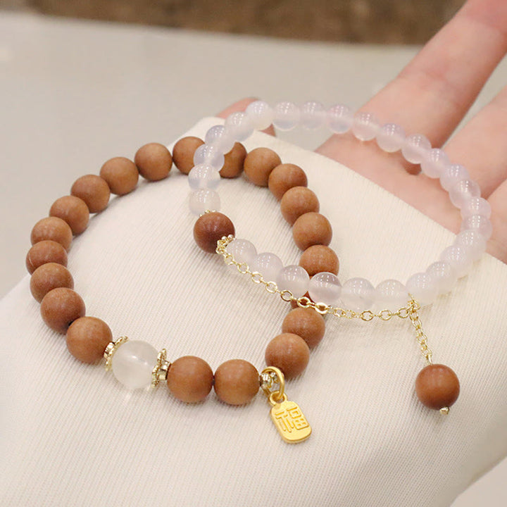 Buddha Stones Armband met bedeltje van sandelhout, kattenoog en Fu-figuur. - image 13