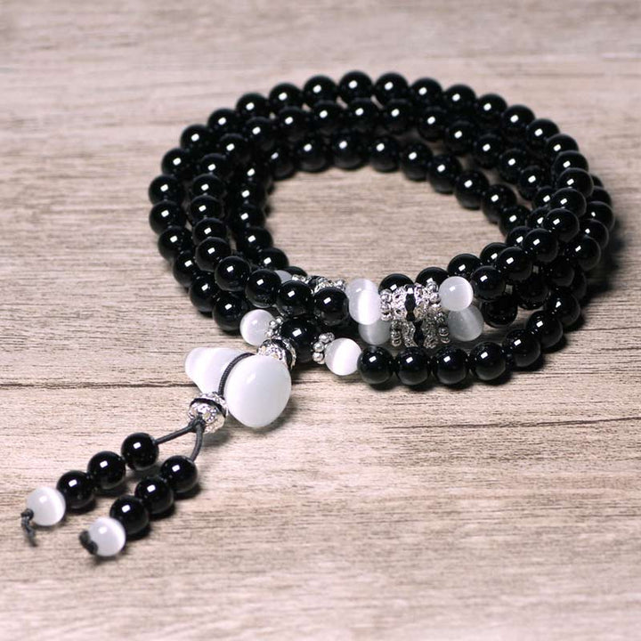 Buddha Stones Armband met kralen van zwarte onyx en witte kristallen - image 1