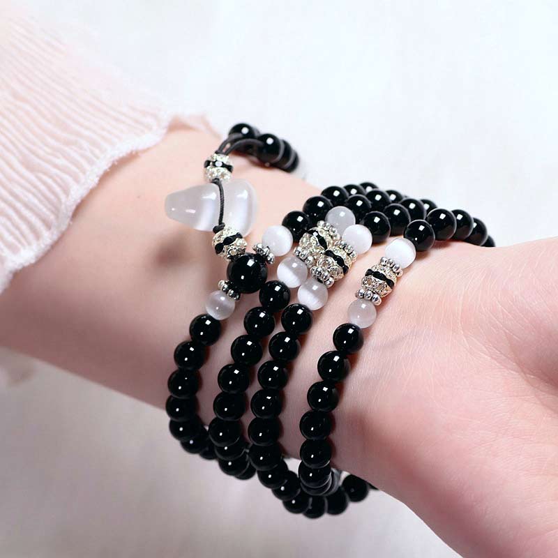 Buddha Stones Armband met kralen van zwarte onyx en witte kristallen - image 2