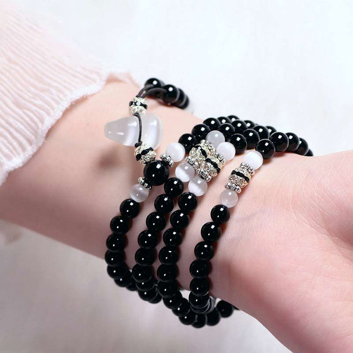 Buddha Stones Armband met kralen van zwarte onyx en witte kristallen - image 2